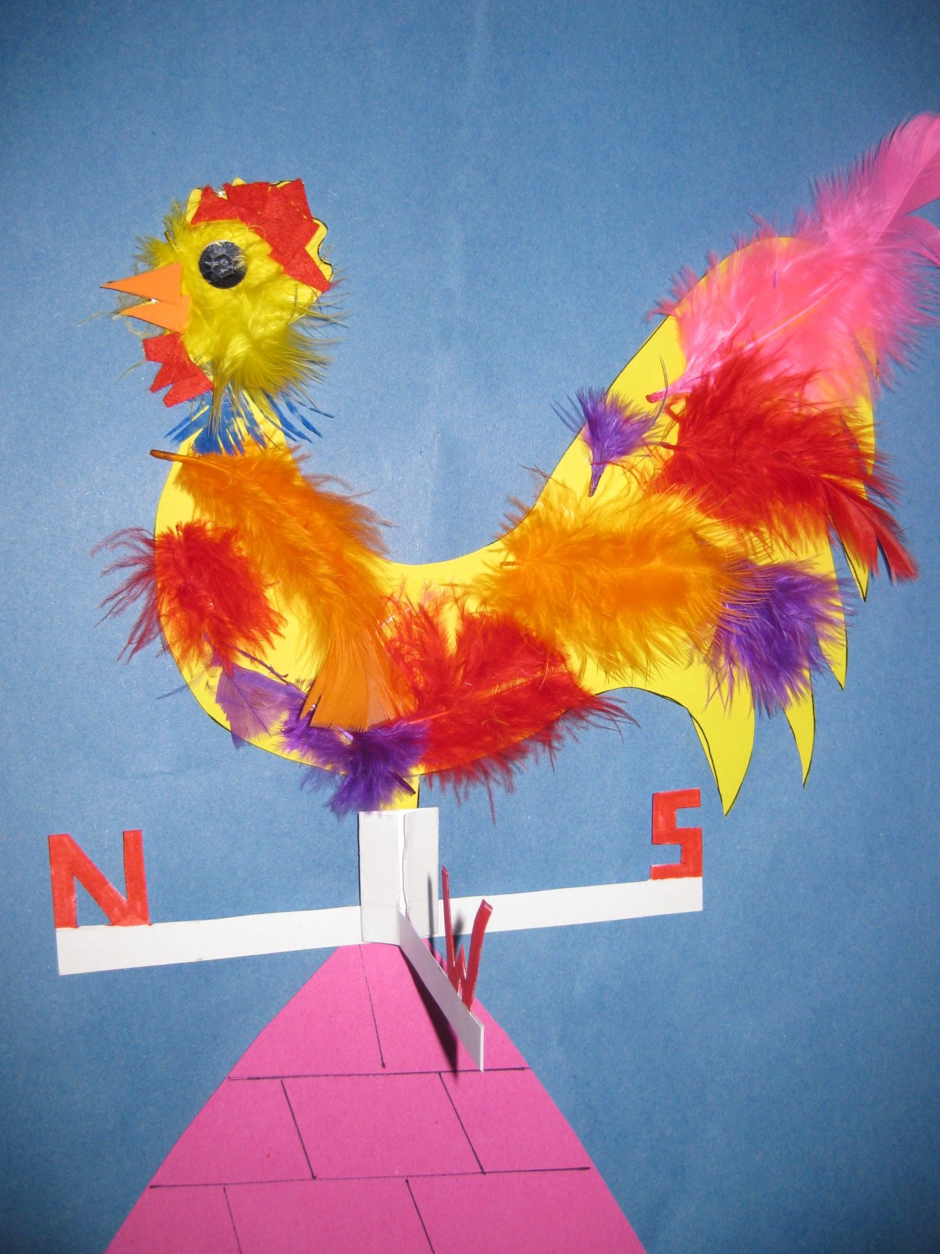 a cockerel decorated with collage